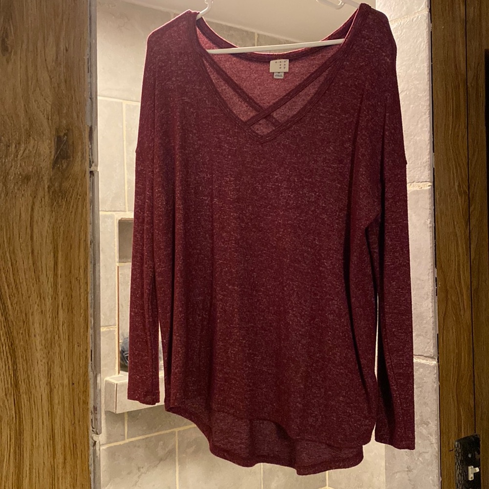 Woman’s size M, long sleeve, maroon shirt.